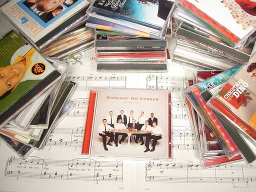 Christmas Music CD's piled on table Christmas Music CD's piled on table