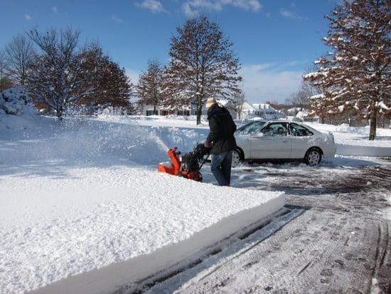 snow blowing a driveway