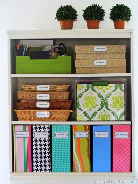 white bookcase with colorful labeled file boxes and baskets