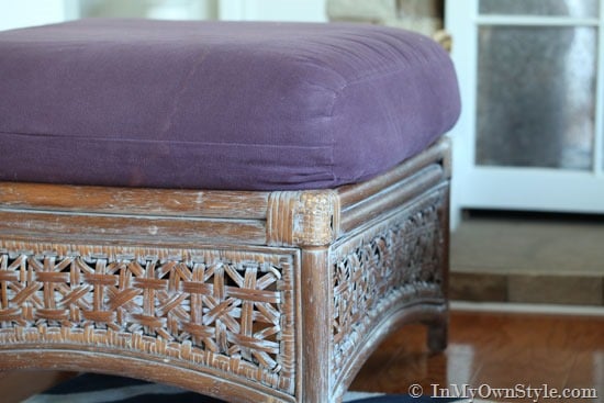rattan ottoman with purple cushion