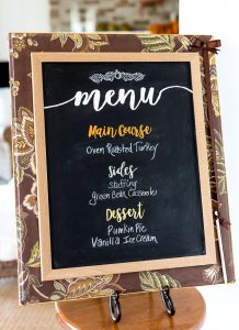 Fabric covered chalkboard in stand in a kitchen