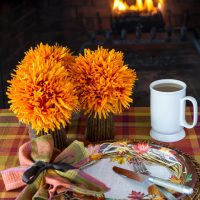 Thanksgiving table setting around the fire set with items from Old Time Pottery
