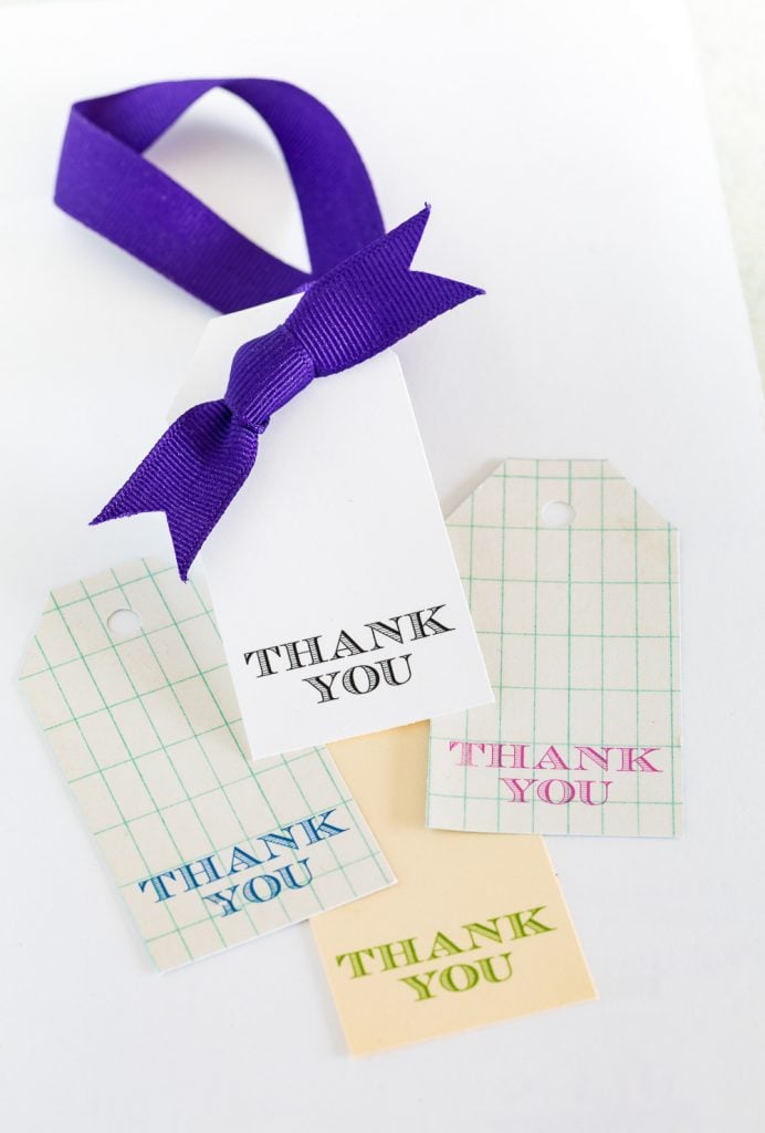 printed free printable gift tag with a ribbon ready to tie on to a wine bottle.