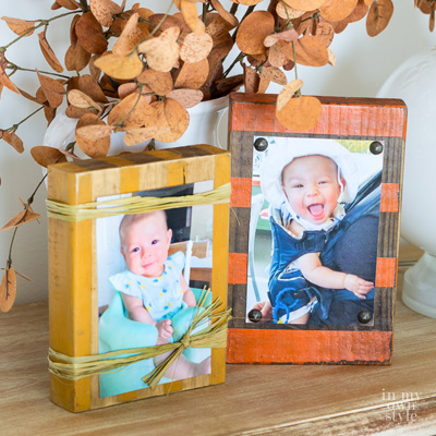 Two fall decorated wood block photo holders on a table