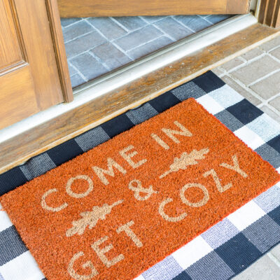 Come In and Get cozy fall doormat on front porch of home