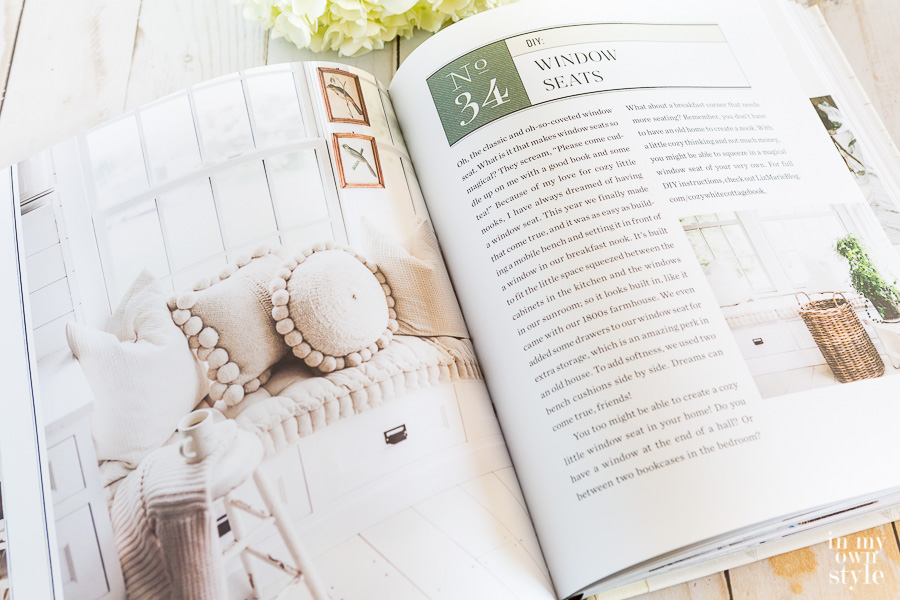 Page open in book titled, Cozy White Cottage about window seat.