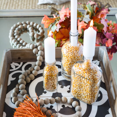 Fall candle holders in a tray on a coffee table