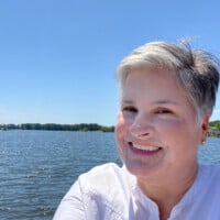 blogger In My Own Style standing on lakeside dock