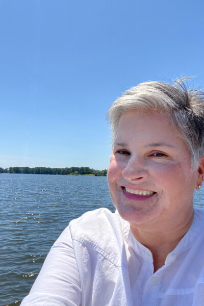 blogger In My Own Style standing on lakeside dock