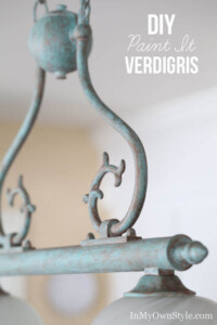 Brass light fixture after being painted to look like Verdigris. Text overlay says DIY paint it Verdigris