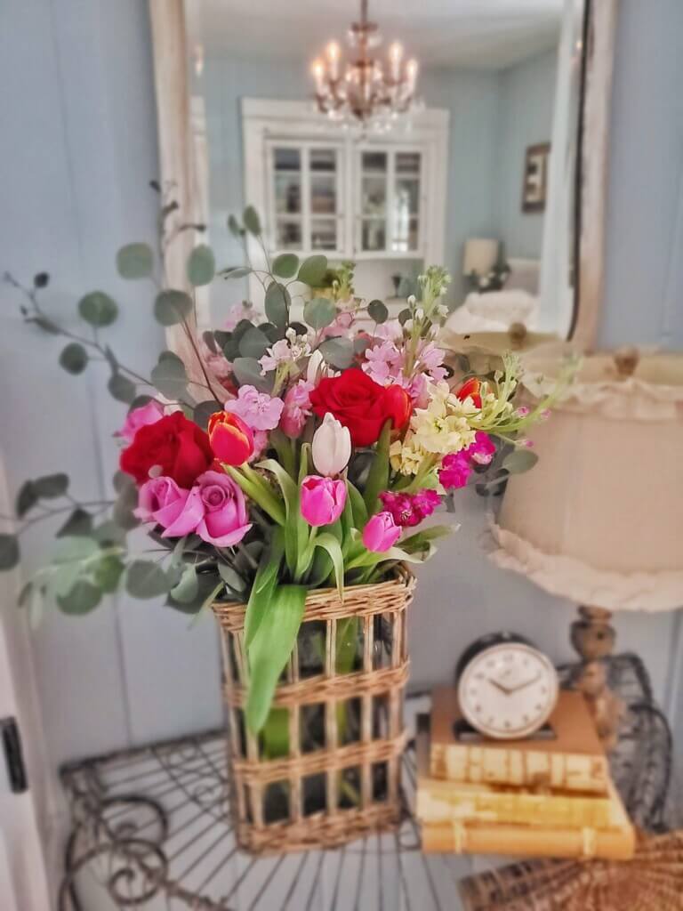 Pretty flowers in basket vase by Shiplap and Seashells.