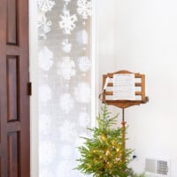 Snowflake window decor. 3 rows of Paper snowflakes hung in a tall window for winter decor.