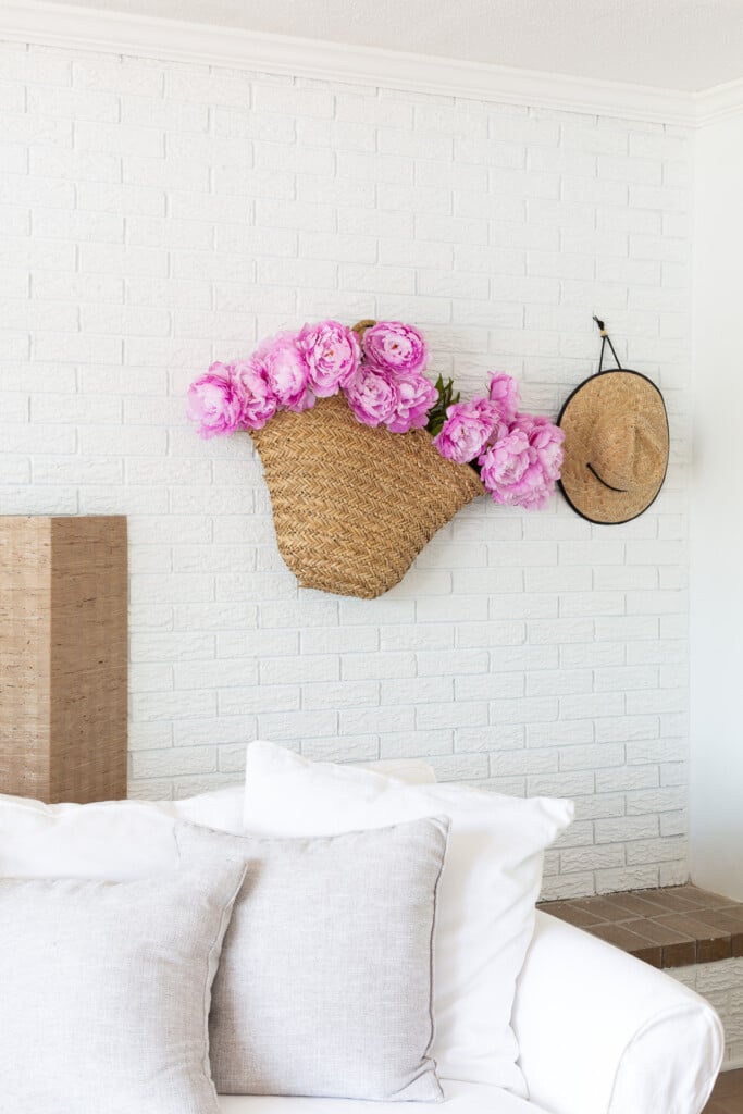 Flowers in a basket hung on a wall for simple summer decorating