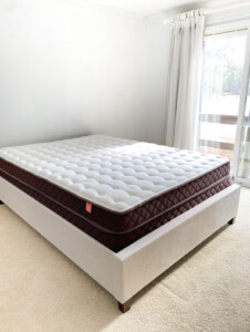 Christeli Charleston mattress in an Eastman upholstered frame in empty bedroom