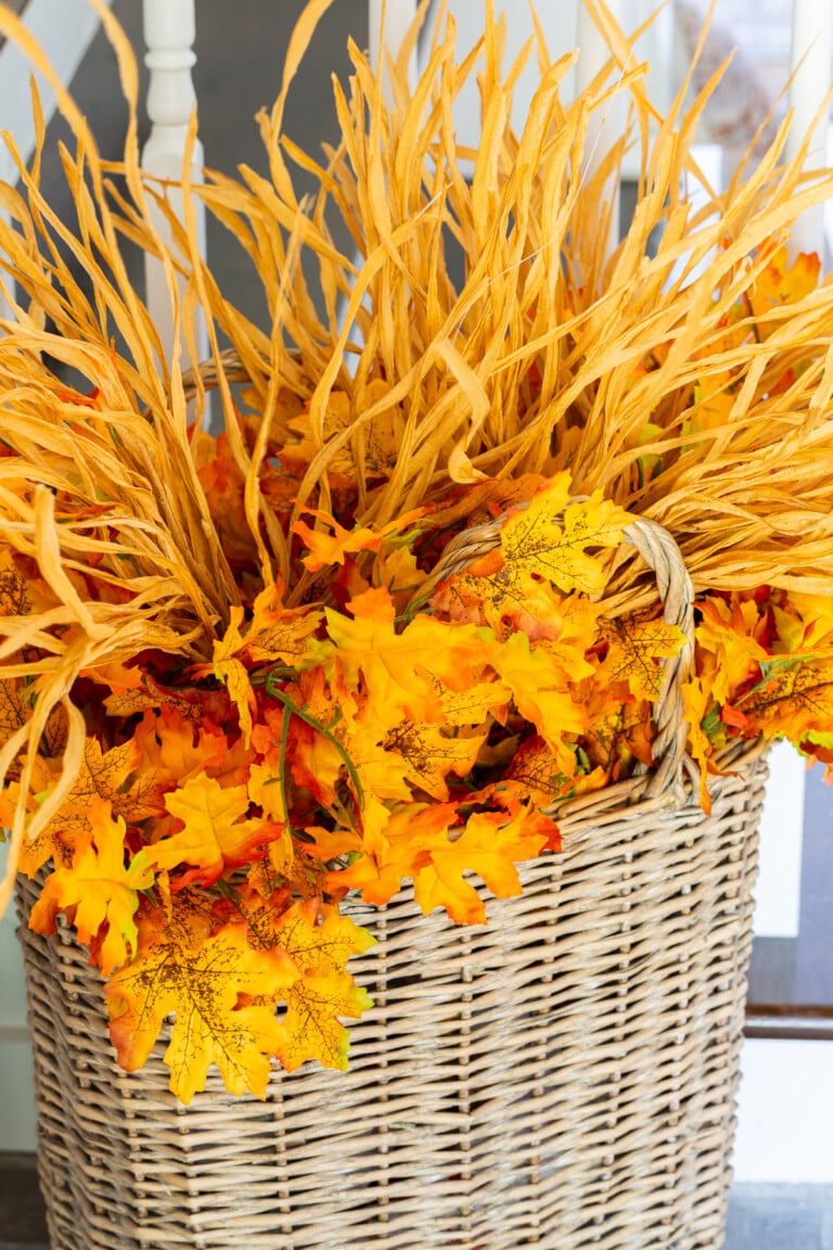 Fall faux foliage in a tall wicker basket