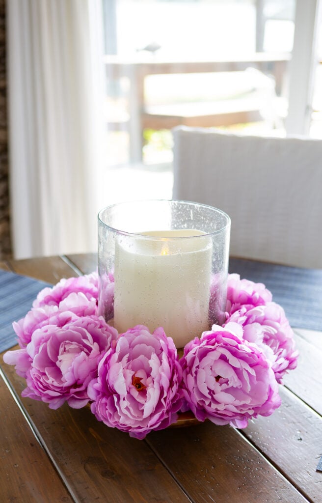 Faux flower heads made into a pretty spring table centerpiece.