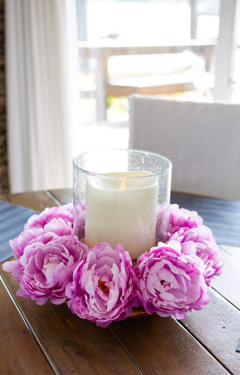 Faux flower heads made into a pretty spring table centerpiece.
