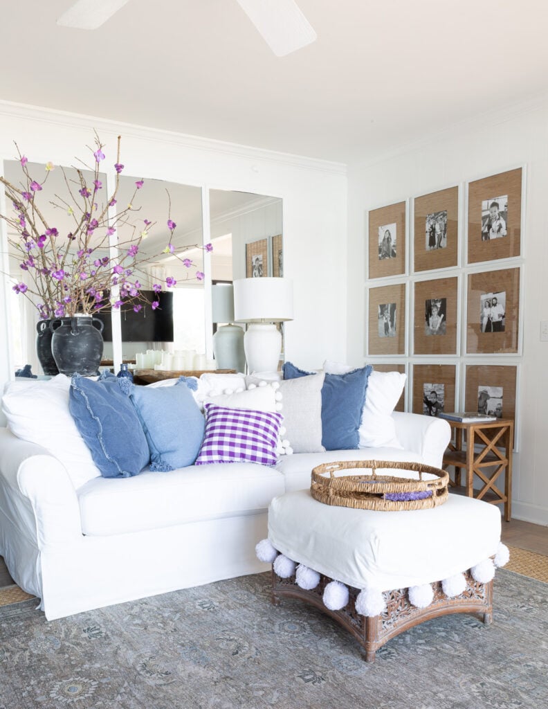 Corner of white wall living room with blue and purple accents.