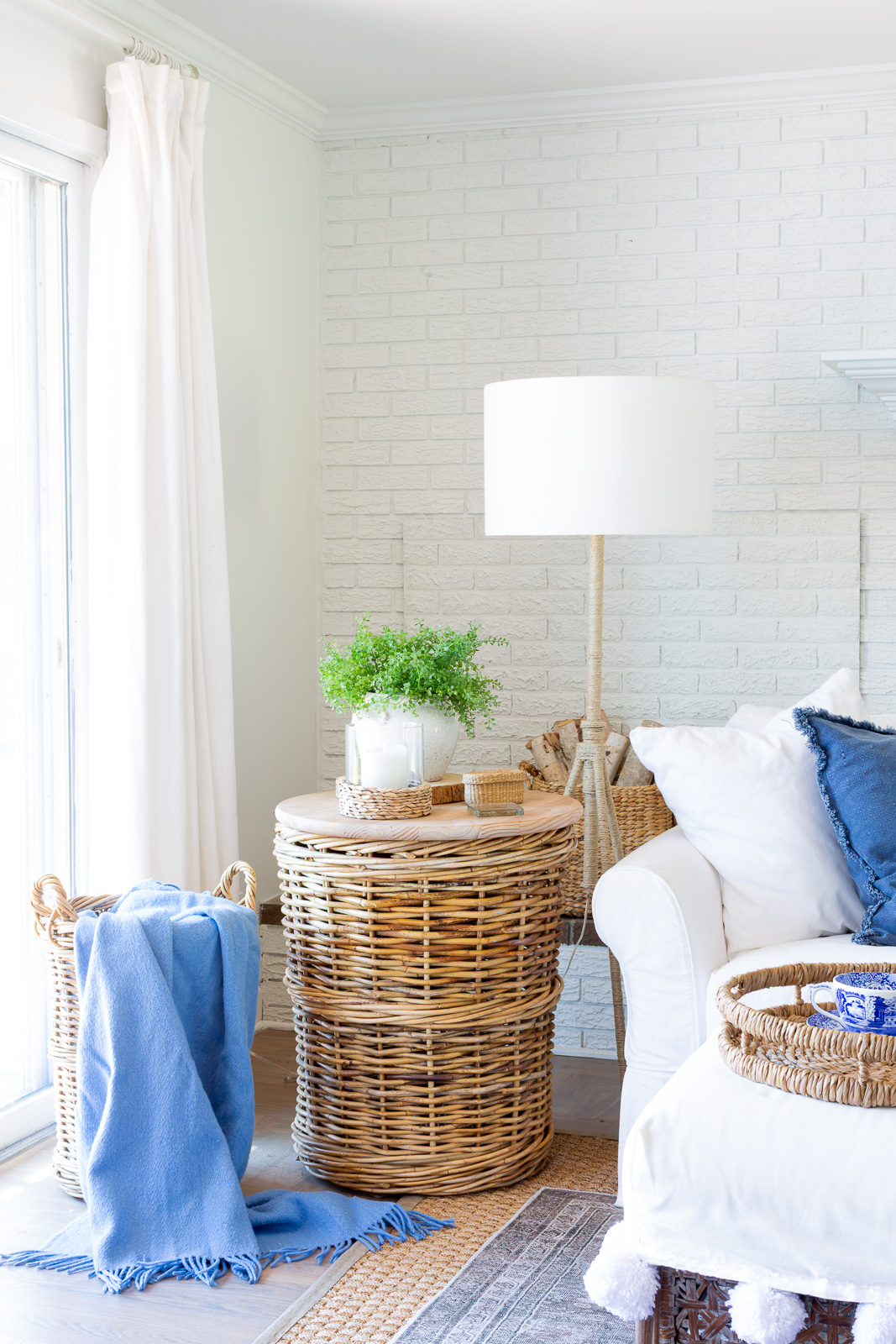 Basket side table in blue and white decorated living room for summer