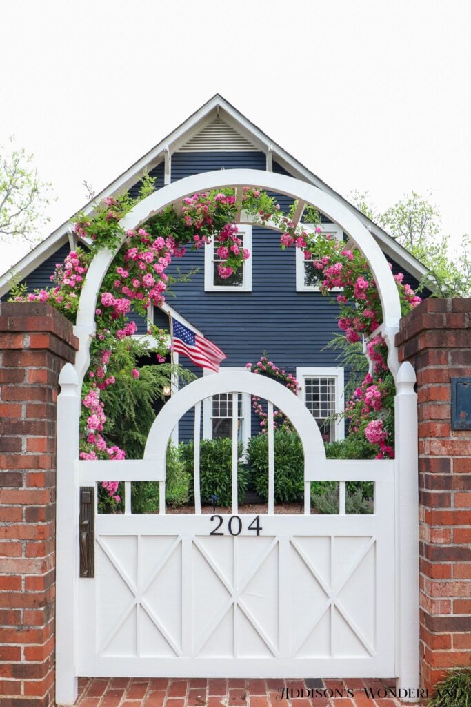 Rose trellis on a a decorative white garden gate