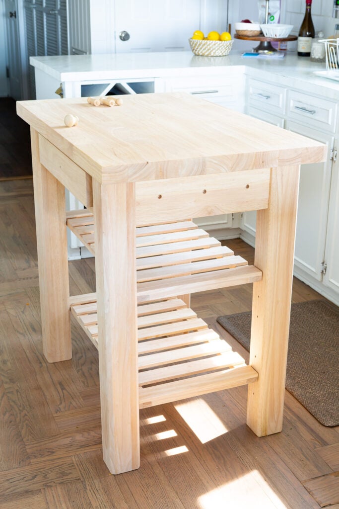 unfinished 24 x 36 Wood kitchen island from Wayfair setup in kitchen before painting.