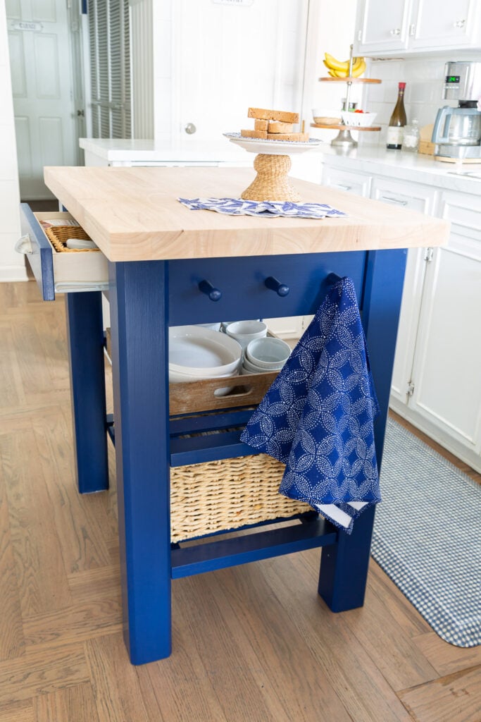 Side view of painted wood island from Wayfair in kitchen.