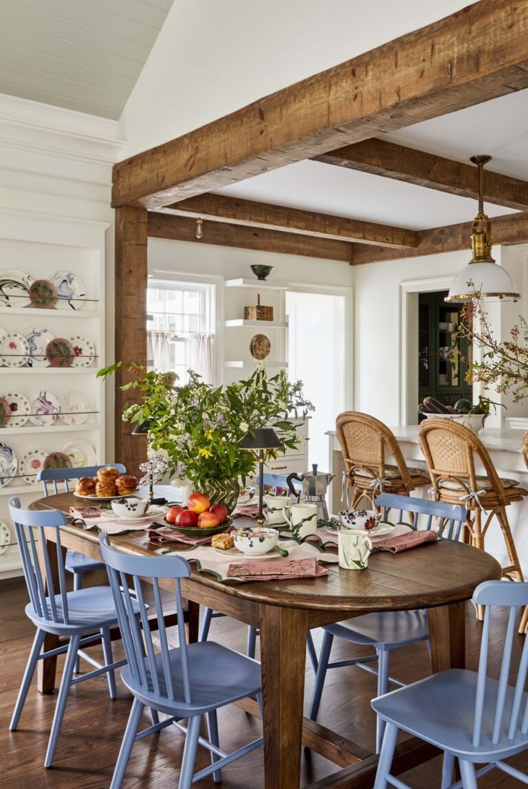 cheery rustic kitchen with stained dining table and blue chairs