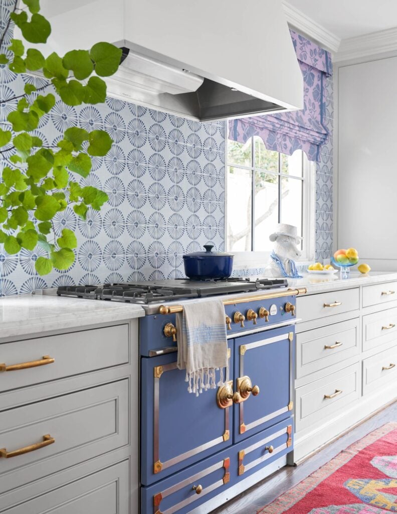 blue and white kitchen with blue and gold copper details