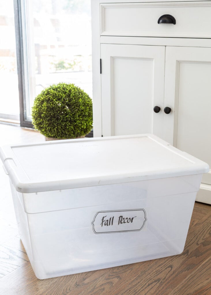 an empty plastic storage bin that held fall decor