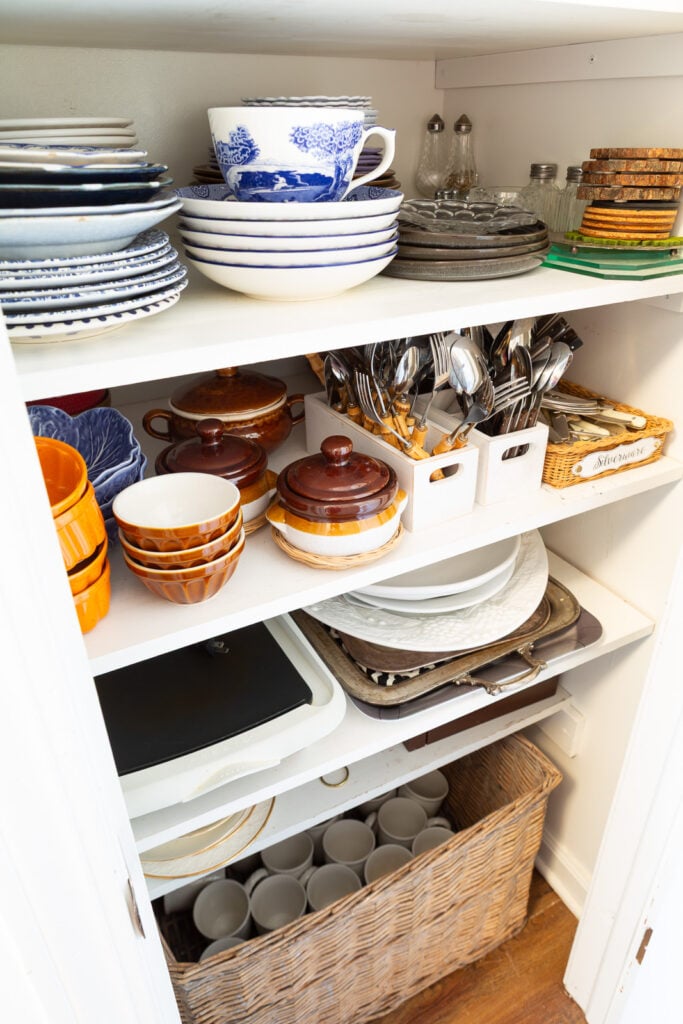 Looking into a china closet where I store fall and autumn colored plates and tableware.