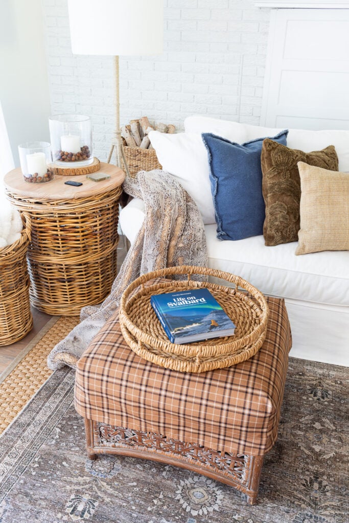 looking down on a white blue and brown living room getting layers of fall decor started.