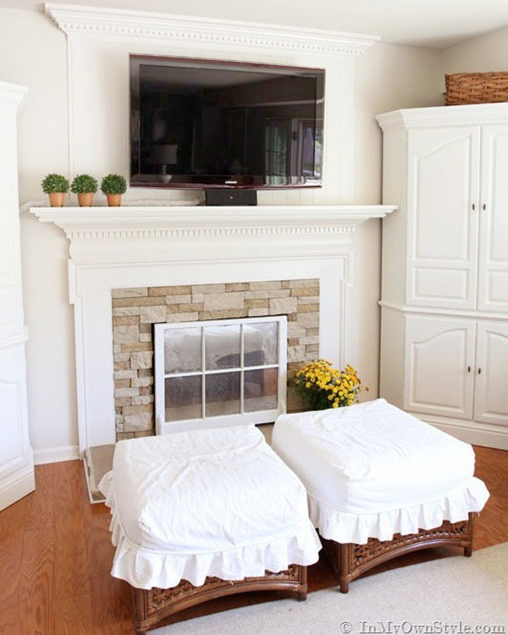 Ottoman-slipcovers-with-ruffles in a family room