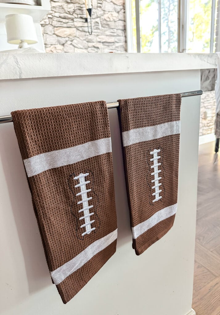 2 football dishtowels on towel rack