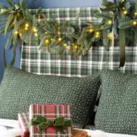 King of Christmas garland draped over bed headboard.