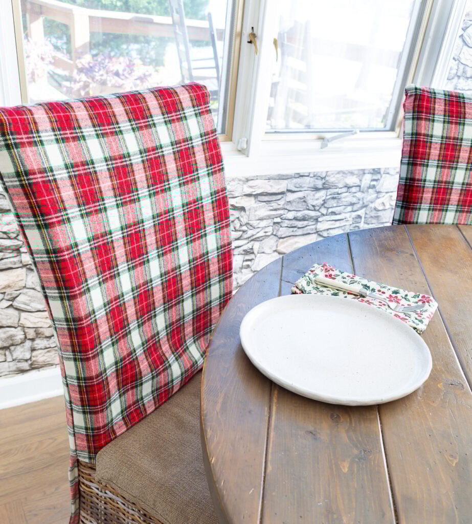 Red and white Christmas plaid fabric made into dining room chair back covers.