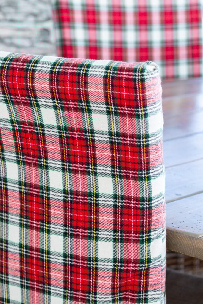 Close up of back of dining chair covered with classic Christmas plaid fabric.