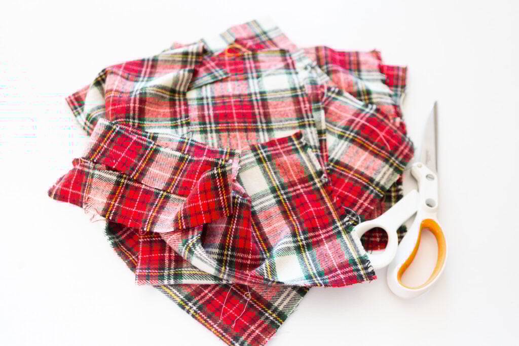 scraps of classic Christmas plaid fabric and a pair of fabric scissors.