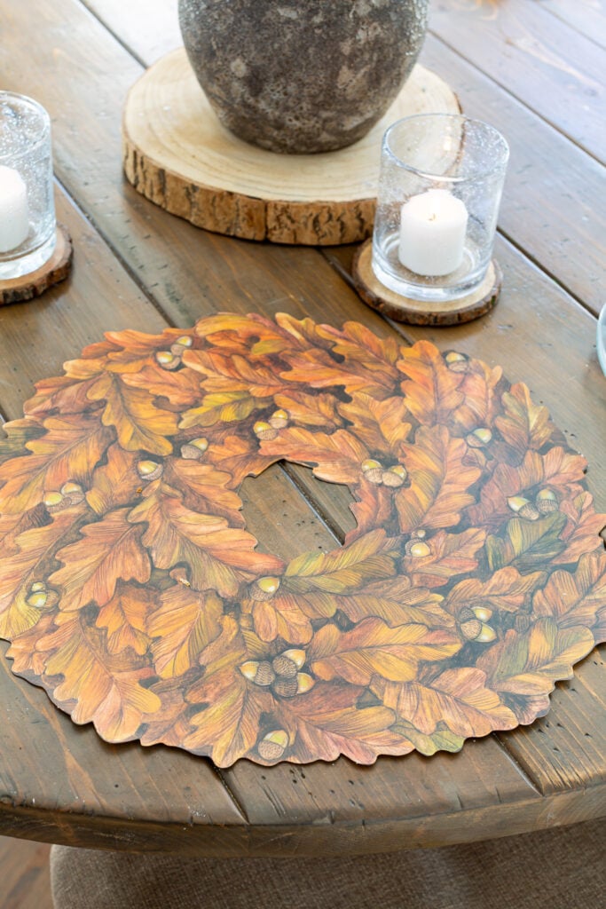 An Autumn Wreath paper placemat by Hester & Cook on a Fall dinner table.
