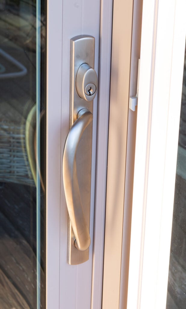 close up of burnished chrome sliding glass door handle