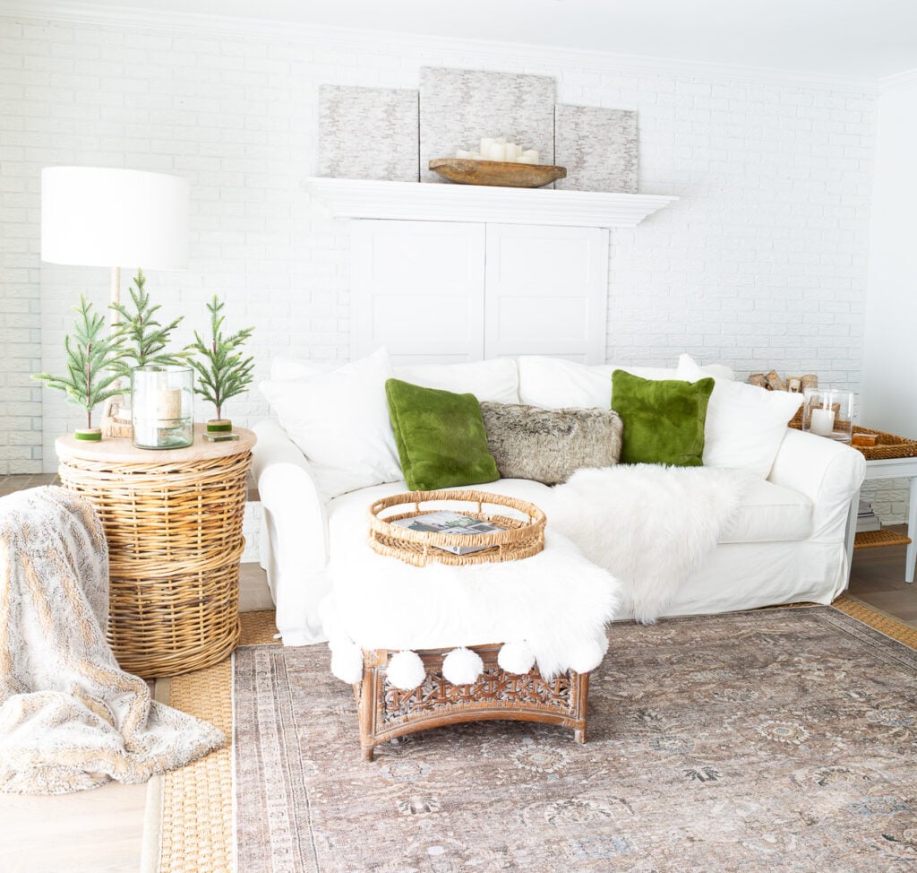 a calm and peaceful neutral decorated living room with woven and green accents
