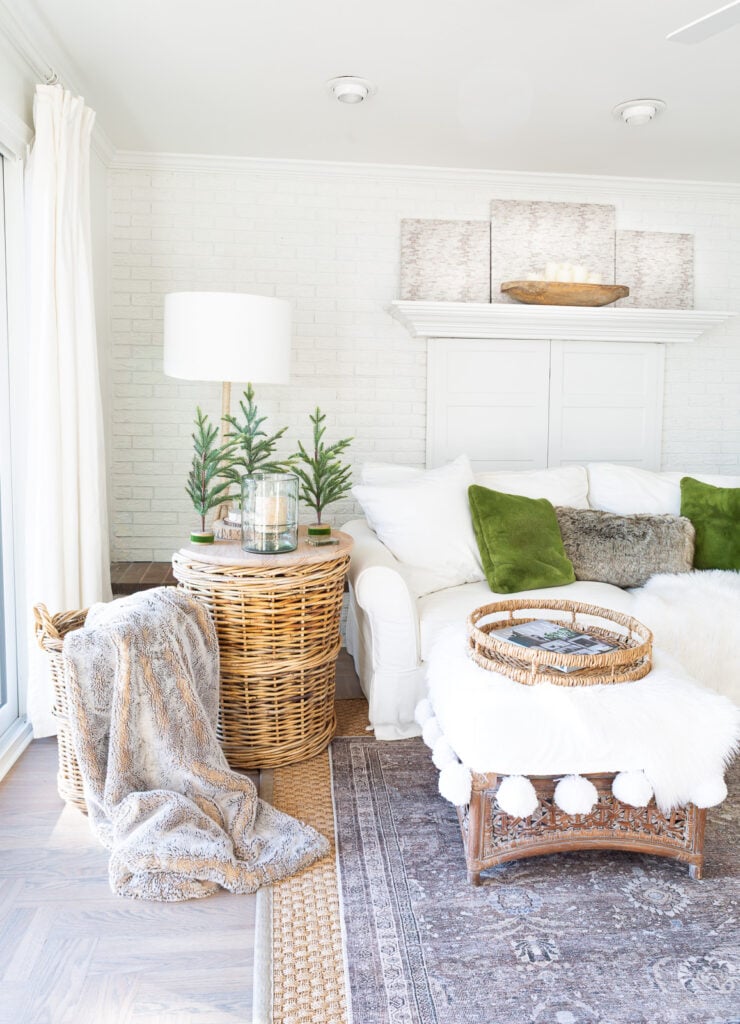a calm and peaceful neutral decorated living room with green accents