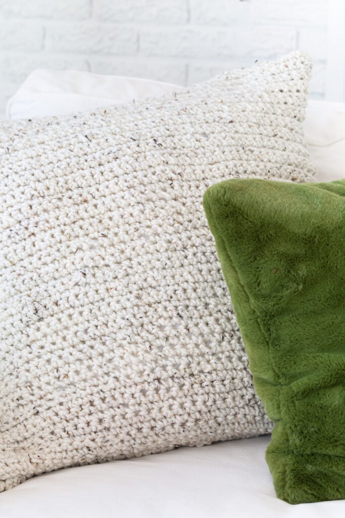 Close up the crocheted pillow cover on sofa.