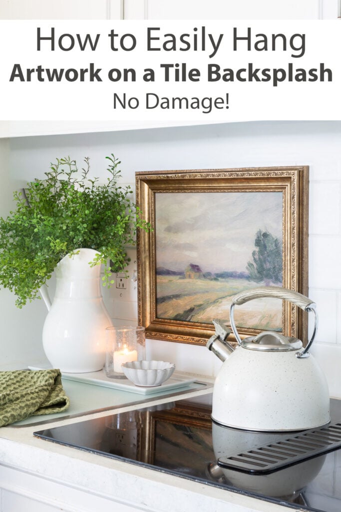 White kitchen showing how to hang art on a tile backsplash