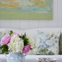 pretty vase of flowers on a table in a room filled with spring colors.