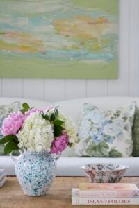 pretty vase of flowers on a table in a room filled with spring colors.