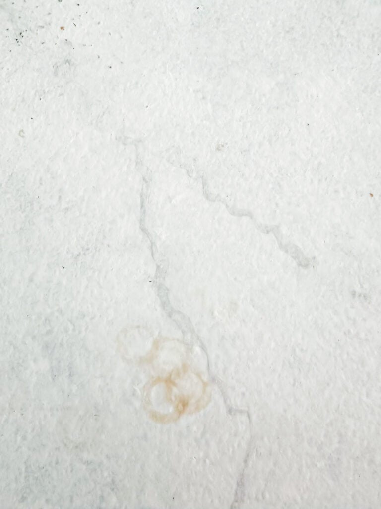 close up of staining on painted kitchen countertops