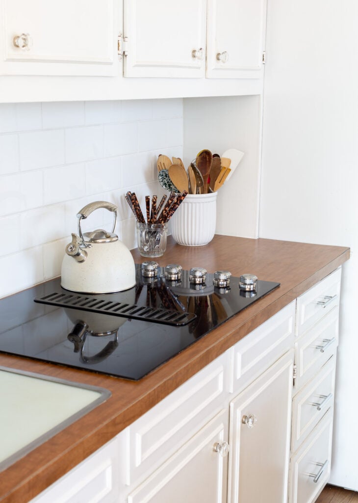 kitchen cooktop area with brown Formica counters
