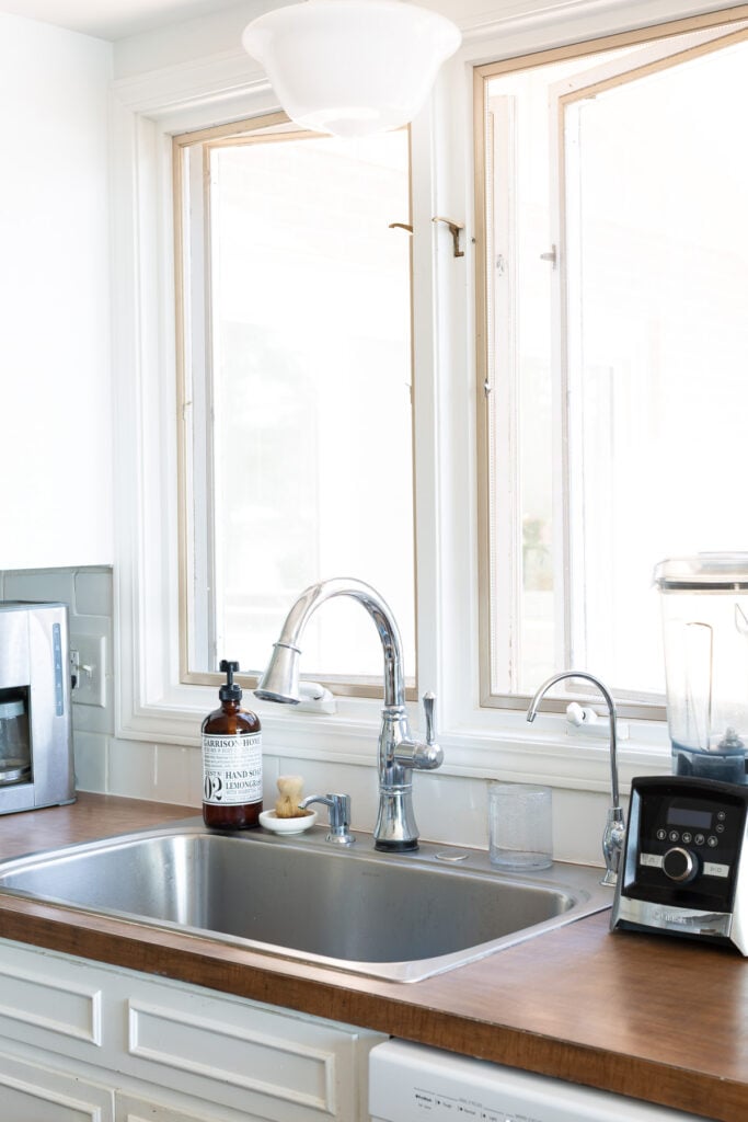 kitchen sink area with brown Formica counters