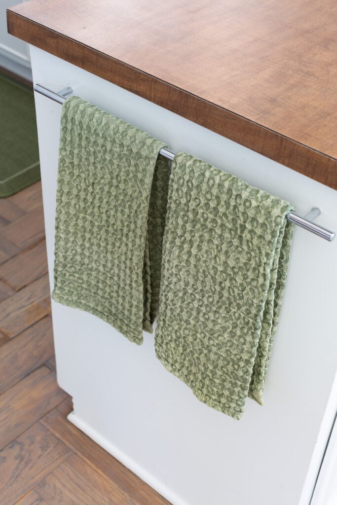 looking down at 2 sage green waffle weave dish towels