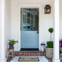 a blue dutch door at the entry of a home